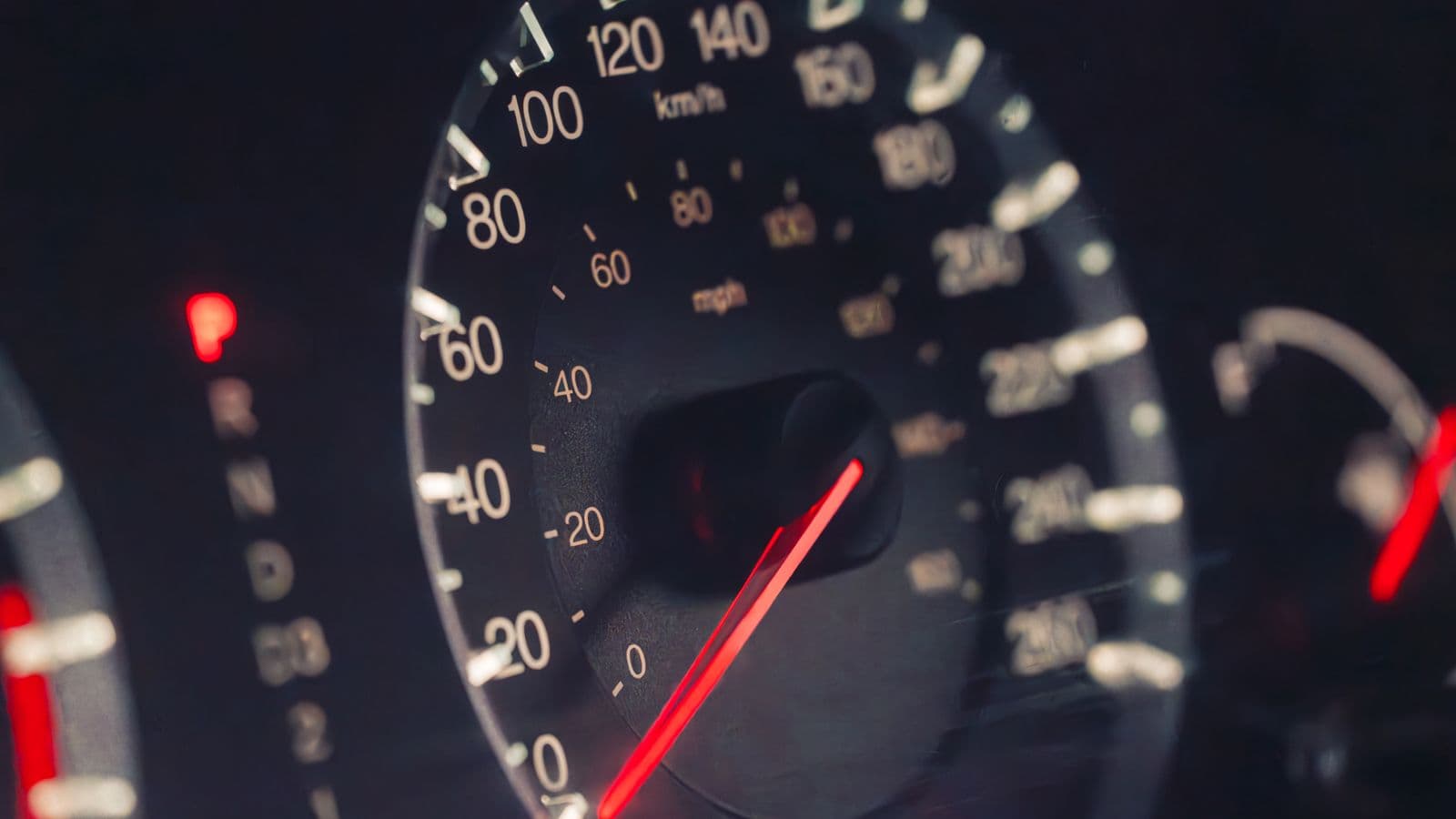 A car's odometer and dashboard while driving, representing the IRS standard mileage rate used to calculate reimbursement