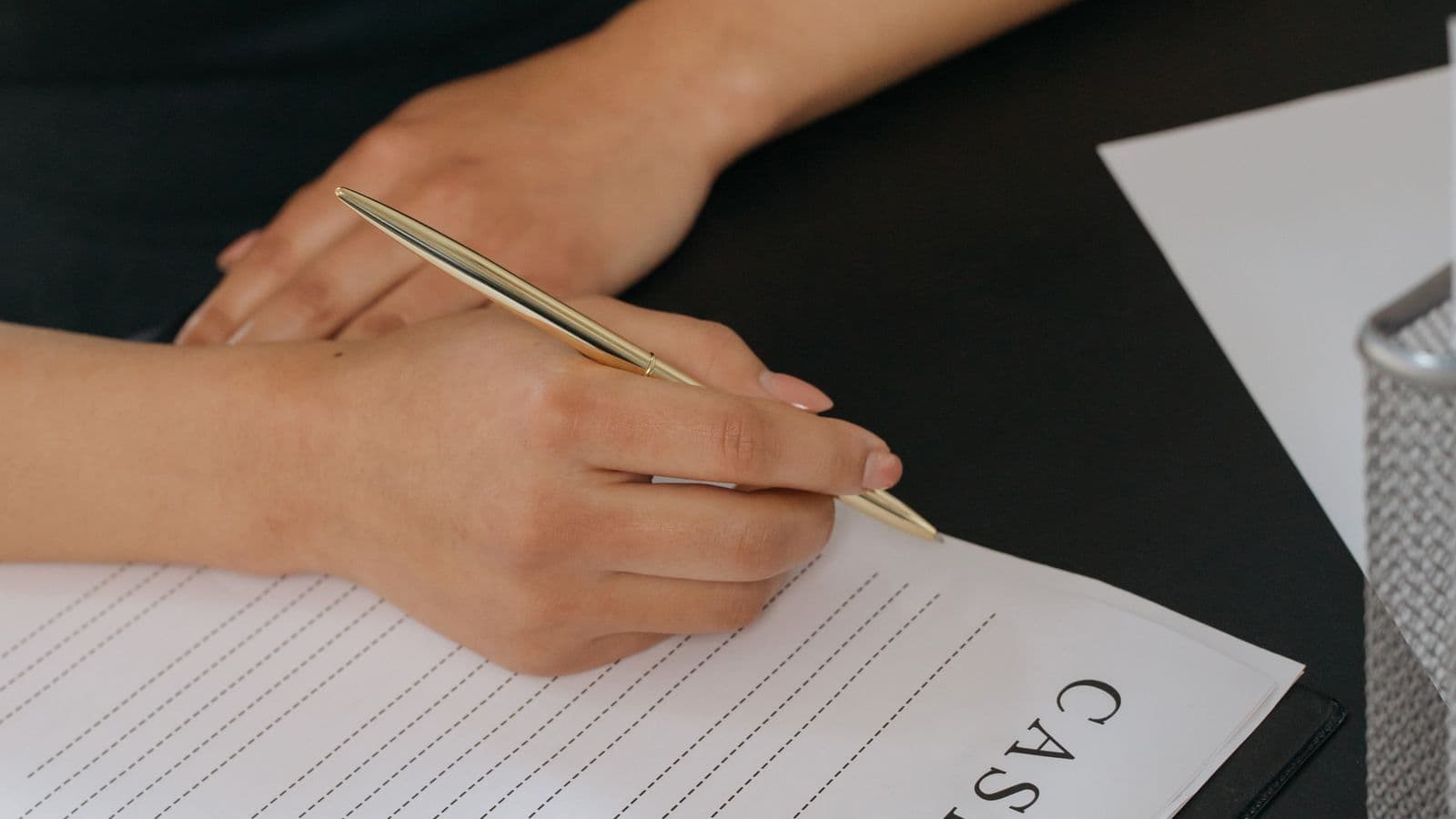 Paperwork and a pen on a desk, representing how to claim a mileage deduction on your taxes