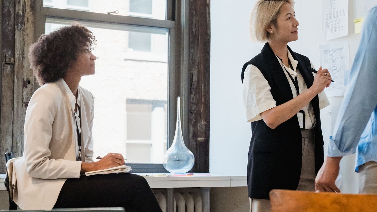 A business team meeting around a table, representing how a company sets its per diem travel policy