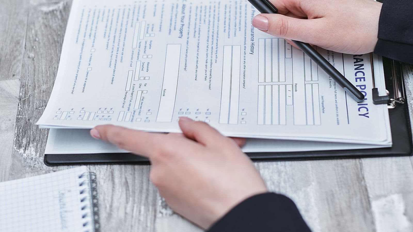 A person reviewing a printed policy document, representing a written mileage reimbursement policy template