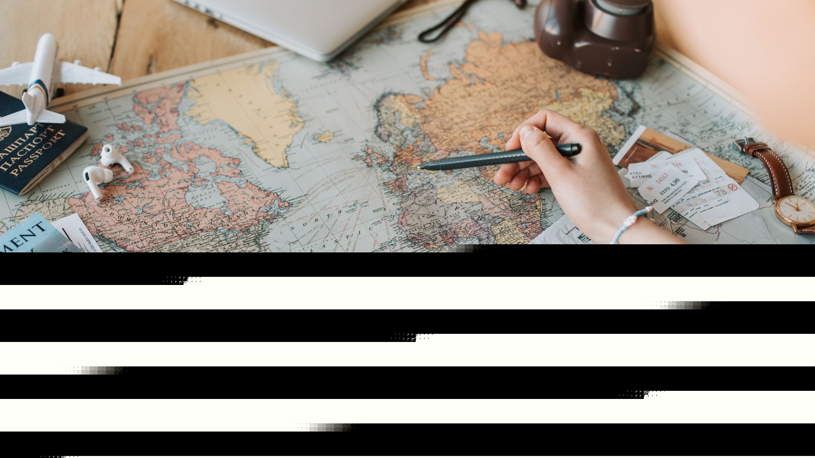 Hands marking destinations on a world map surrounded by travel essentials like passport and camera, representing CONUS and OCONUS travel