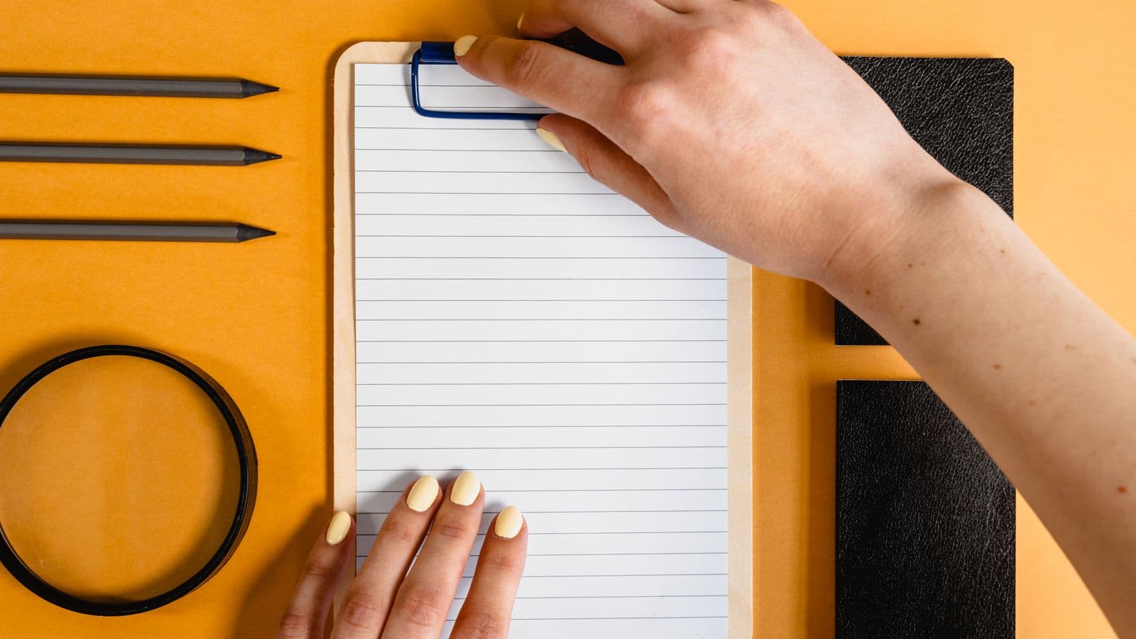 A printed mileage log template on a clipboard resting on a car dashboard, with a pen ready to record a trip