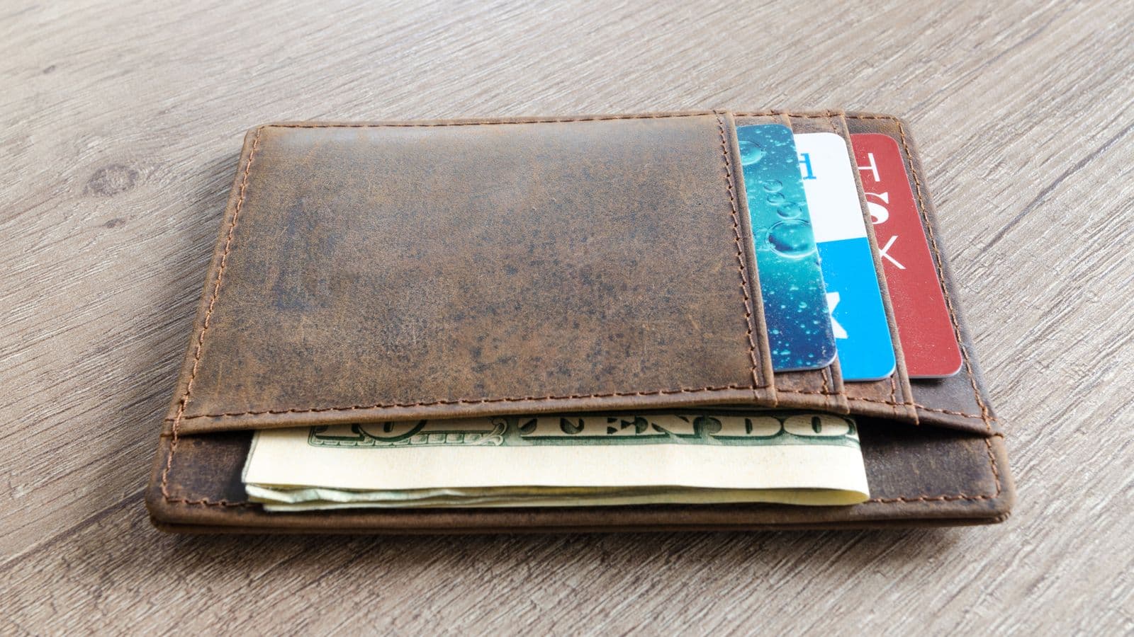 A wallet with cash and a credit card, representing different types of per diem allowance