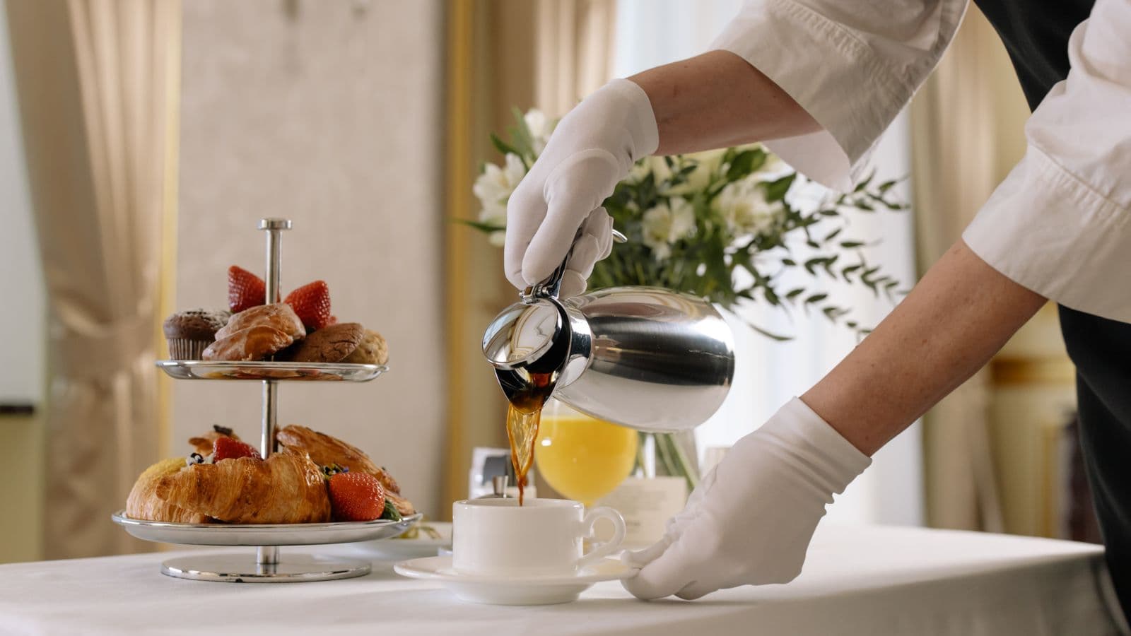 A hotel breakfast tray with coffee and pastries, representing what a per diem meal allowance covers